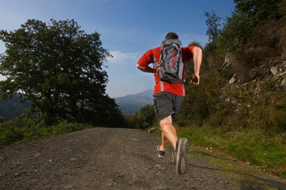 man running on mountain path